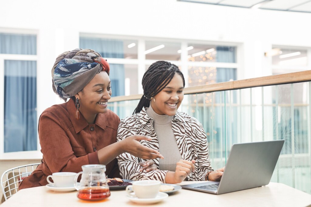 Two women in conversation over a laptop