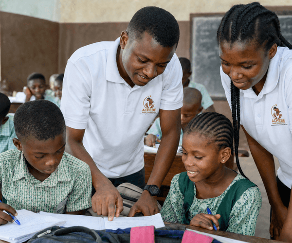 Foundation volunteers tutoring pupils in a classroom